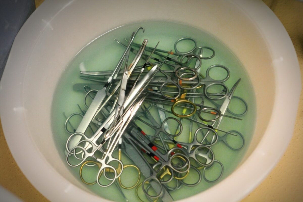 Surgical scissors in a cleaning setup illustrating instrument care and inspection